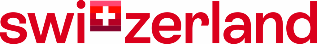 Das Wort Schweiz mit einer Schweizer Flagge anstelle des t in fetter roter Schrift auf hellem Hintergrund - perfekt für eine Hochzeitsplanung oder einen Wedding Planner, der sich auf Feiern von der Schweiz bis Italien spezialisiert hat.